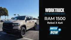 2025 Ram 1500 Rebel X 4x4 parked near marina with palm trees, featuring Mojave Sand paint, black grille, and off-road tires in a Work Truck video series spotlight.