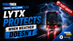 A dramatic YouTube thumbnail showing a semi-truck driving through heavy rain and lightning on a dark highway, with bold text reading “LYTX Protects When Weather Doesn’t.” The Work Truck logo appears in the corner, along with a red “Fleet Safety” banner.
