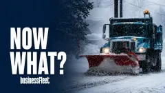Snowplow truck driving through heavy snowfall with the words “Now What?” displayed beside it.
