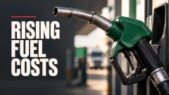 Green fuel nozzle at a fueling station beside bold white text reading “Rising Fuel Costs.”