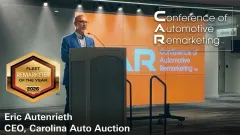 Eric Autenrieth accepts the Fleet Remarketer of the Year award on a stage at the CAR Conference in Cleveland, OH.