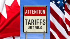 U.S. and Canadian flags and sign that says tariffs ahead