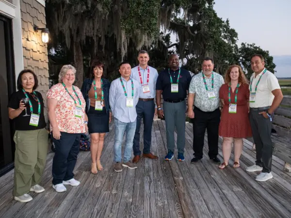 Attendees posing for photos outside. 