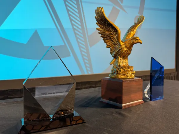 three awards on a table