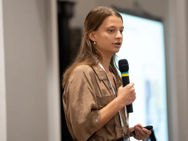Woman with microphone making presentation. 