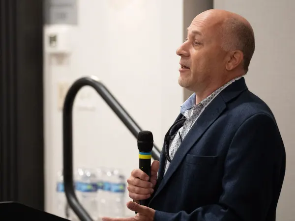 Man with microphone making presentation. 