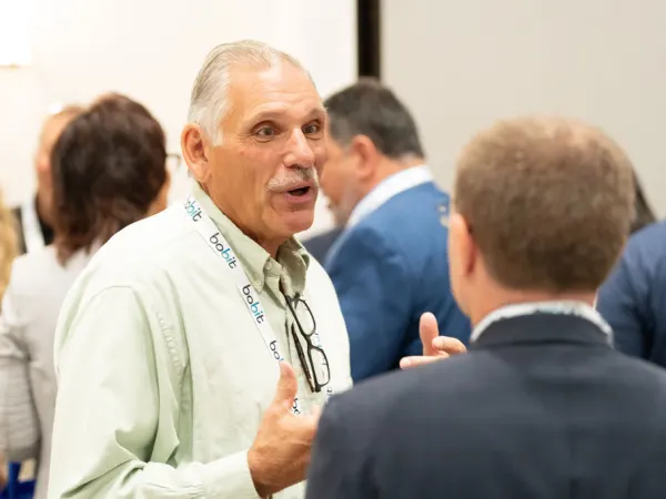 Man in discussion during networking break. 