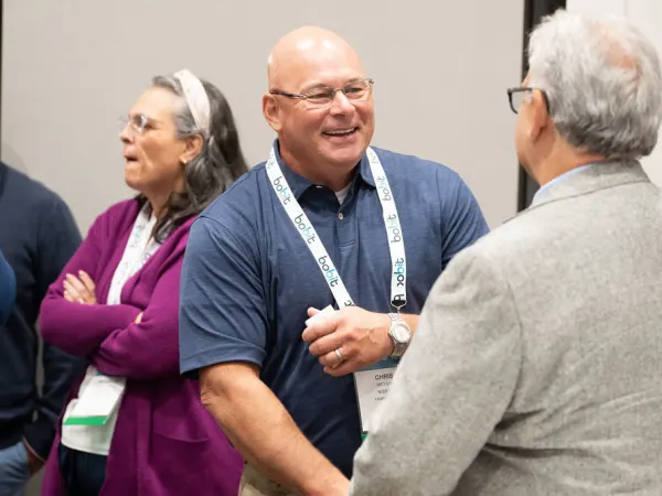 Man in discussion during networking break. 