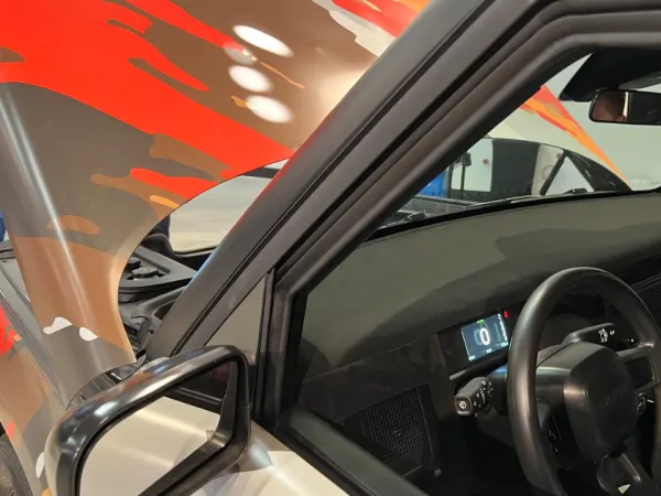 Photo of steering wheel and left dashboard.