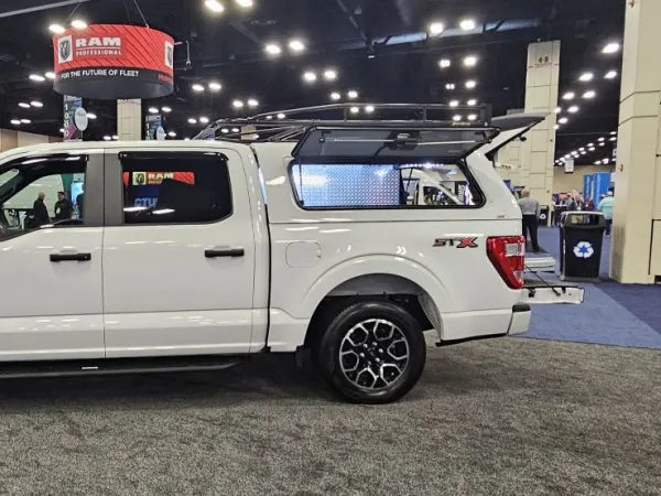 A white four-door pickup truck with upfit