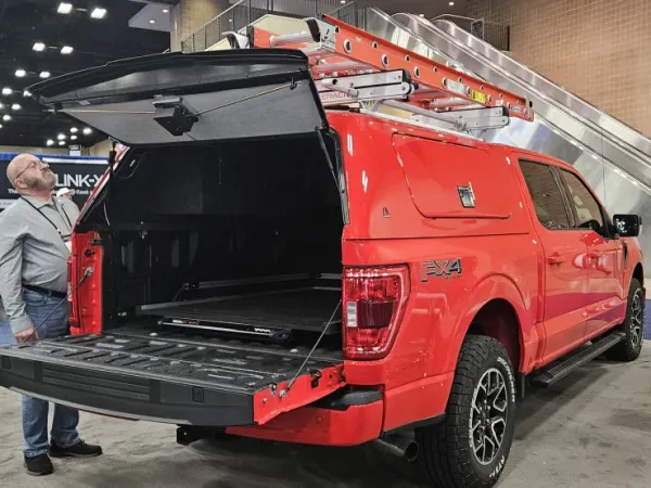 A red pickup truck with Masterack ladder rack