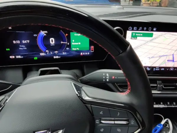 View of the dash, steering wheel, and infotainment screen as seen from the driver's seat.