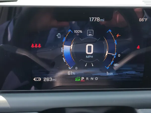 Digital instrument cluster screen with speedometer in the middle.