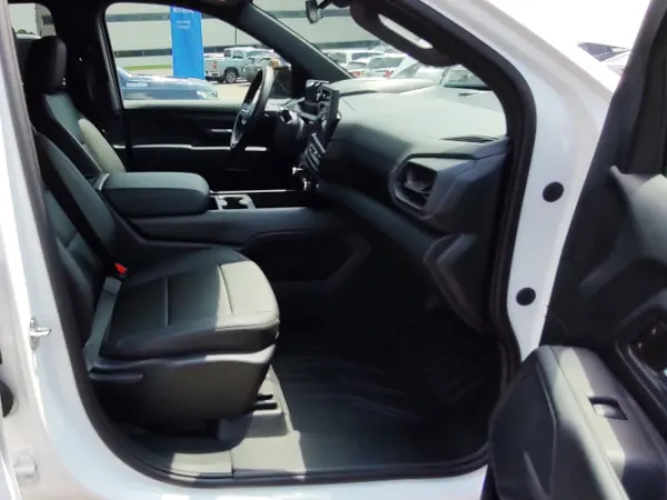 View into the front passenger seat through an open door.
