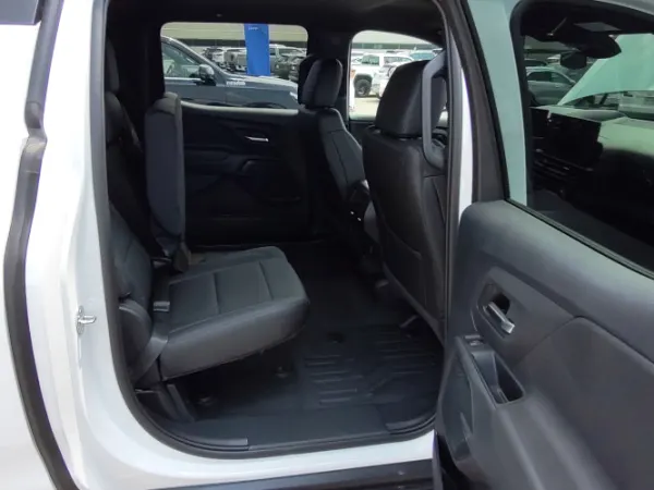 View of the rear passenger seat through an open door.