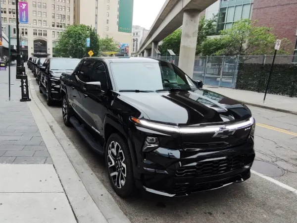 A front-quarter view of a black EV pickup truck.