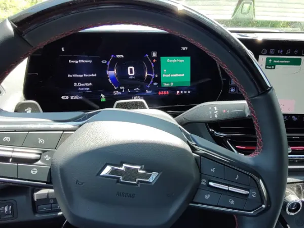 View from driver's position shows steering wheel and dash display.