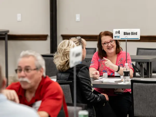 attendees share a lively discussion during a scheduled Work Truck Exchange appointment.