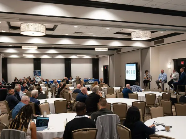 Wide shot of hotel conference room during a presentation. 
