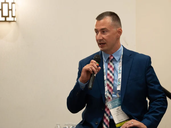 Man with microphone making presentation. 