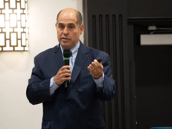Man with microphone making presentation. 