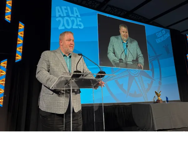 Man gives speech after accepting award.