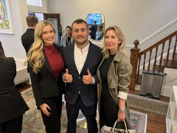 three stand for photo at reception