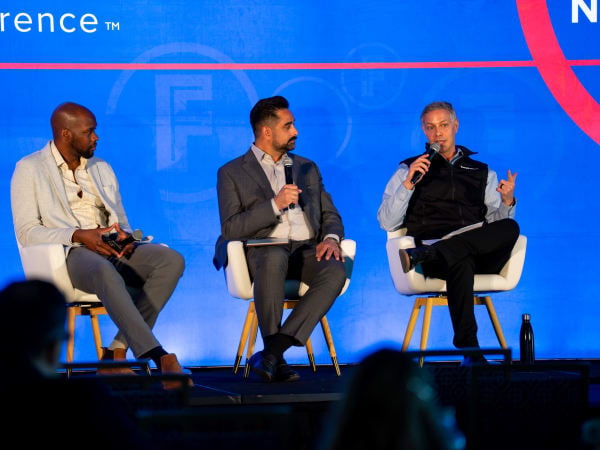 Speakers from Fleet Forward conference sit on stage