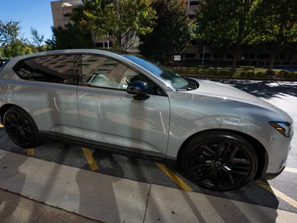 A silver Volvo SUV with black wheels and tinted windows is parked outside the Gaylord National Resort during the 2026 Fleet Forward Conference.
