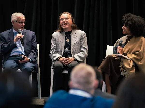 Three fleet pros sit on a stage at FFC2026 talking about  Michael Sims Manager, Global Fleet Services  The Church of Jesus Christ of Latter-day Saints.