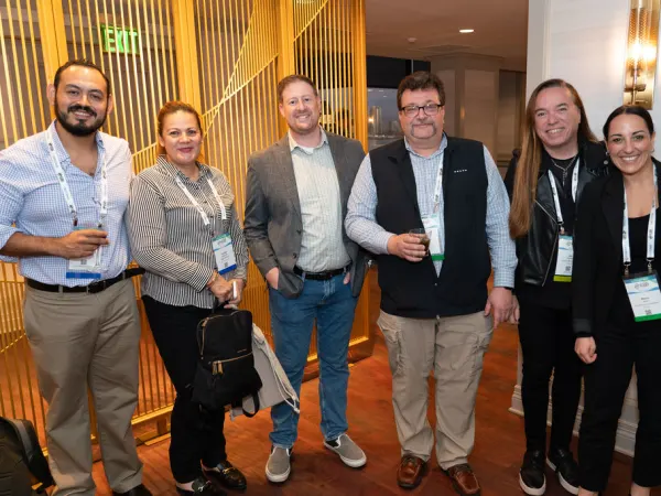 Six attendees at cocktail reception. 