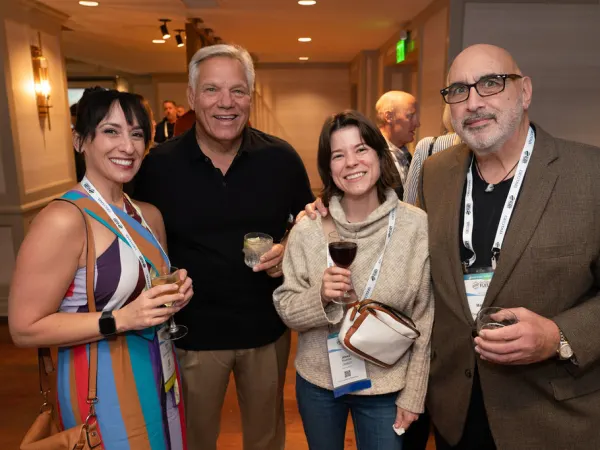Four attendees at cocktail reception. 