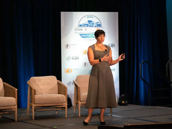 Woman on stage making presentation. 