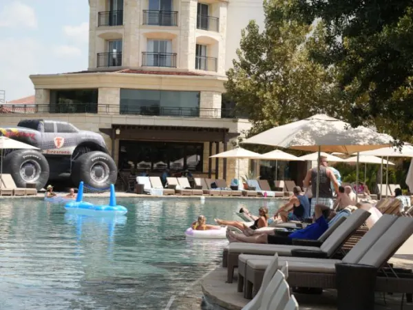 Photo of attendees relaxing by the pool.