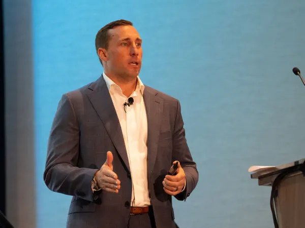 Man gives presentation on stage. 