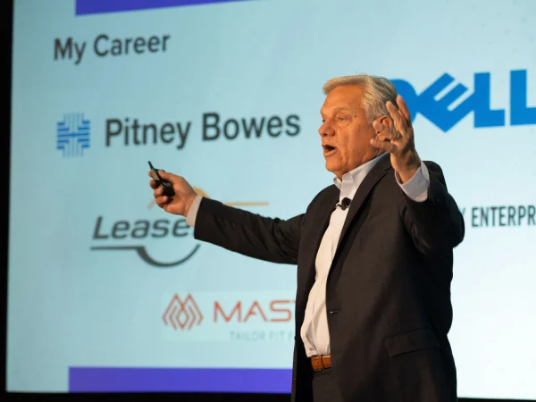 Man gives keynote speech on stage. 