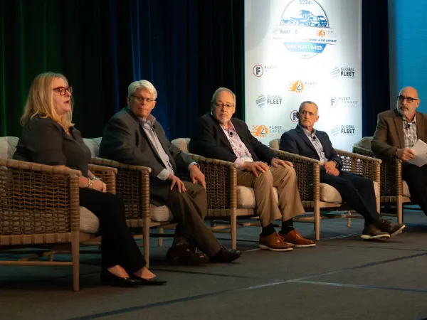 Panelists deliver seminar on stage. 