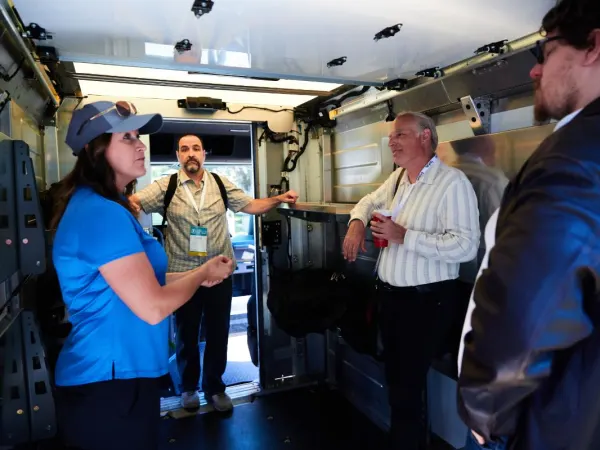 Event attendees inside cargo van. 