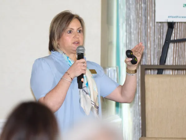 Woman with microphone delivers a seminar. 