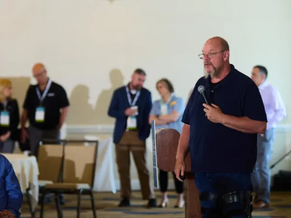 Man with microphone delivers a seminar. 