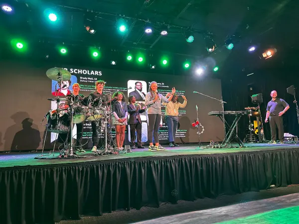 Interns on stage at an offsite party. 