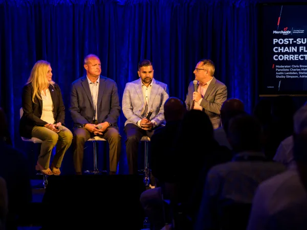 Four panelists on stage during seminar.