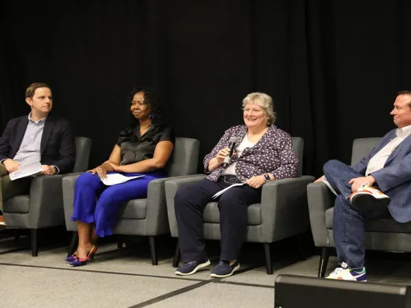 Panelists on stage during a seminar.