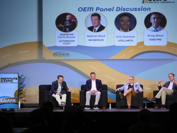 Panelists on stage during a seminar.