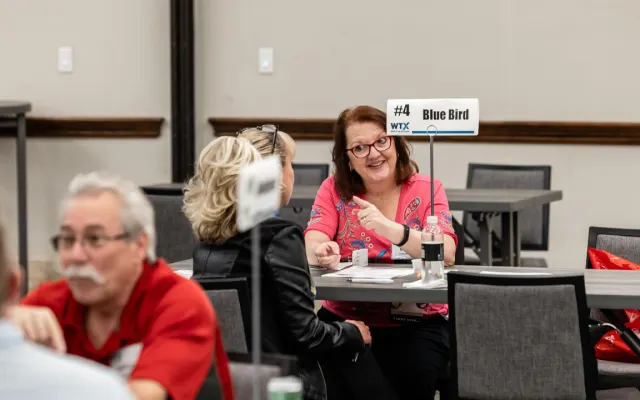 attendees share a lively discussion during a scheduled Work Truck Exchange appointment.