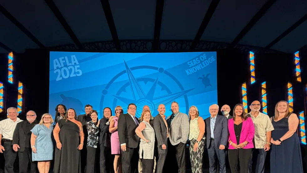 Honorees gather on stage for a photo. 