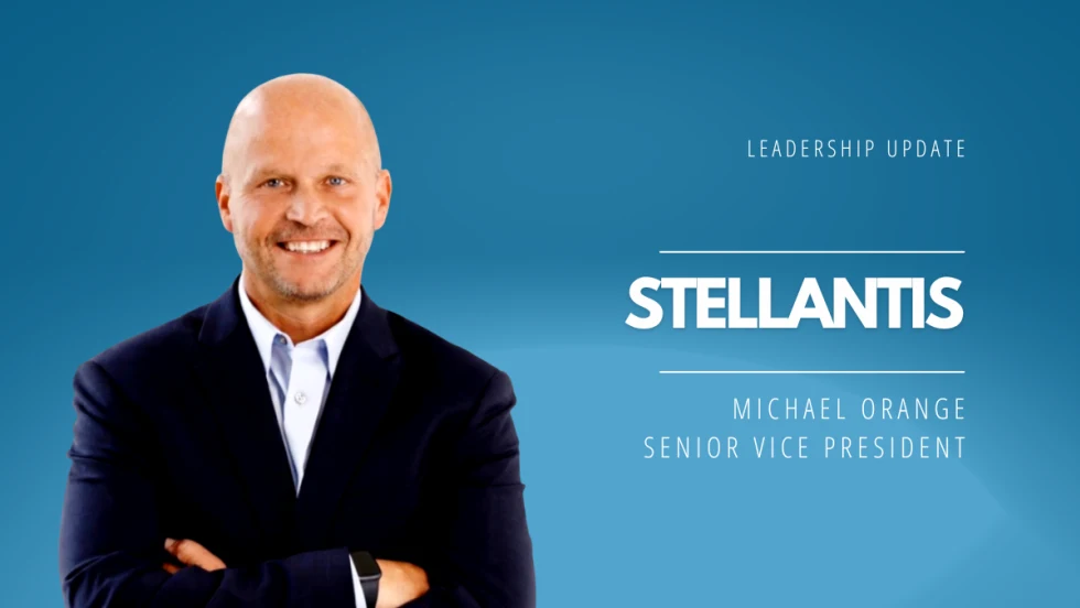 Portrait of Michael Orange in a suit with arms crossed against a blue background, announcing his appointment as Stellantis Senior Vice President leading U.S. sales and network performance.