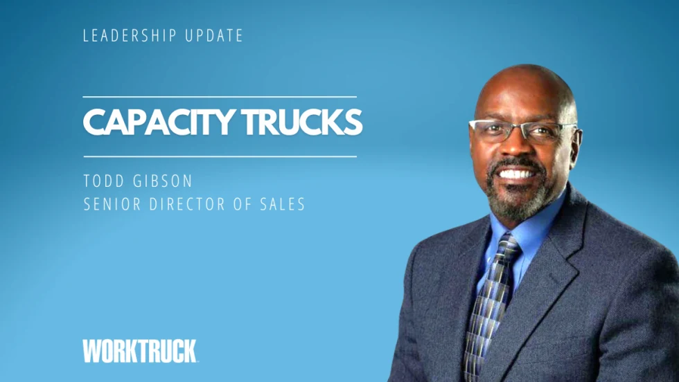 Man in business attire in front of a blue background with white headline Leadership Update and Capacity Trucks, plus a logo for Work Truck.