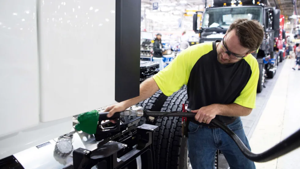 Technician fueling a truck with diesel 