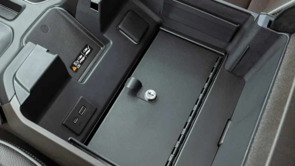 Security safe installed in the center console of a pickup truck.